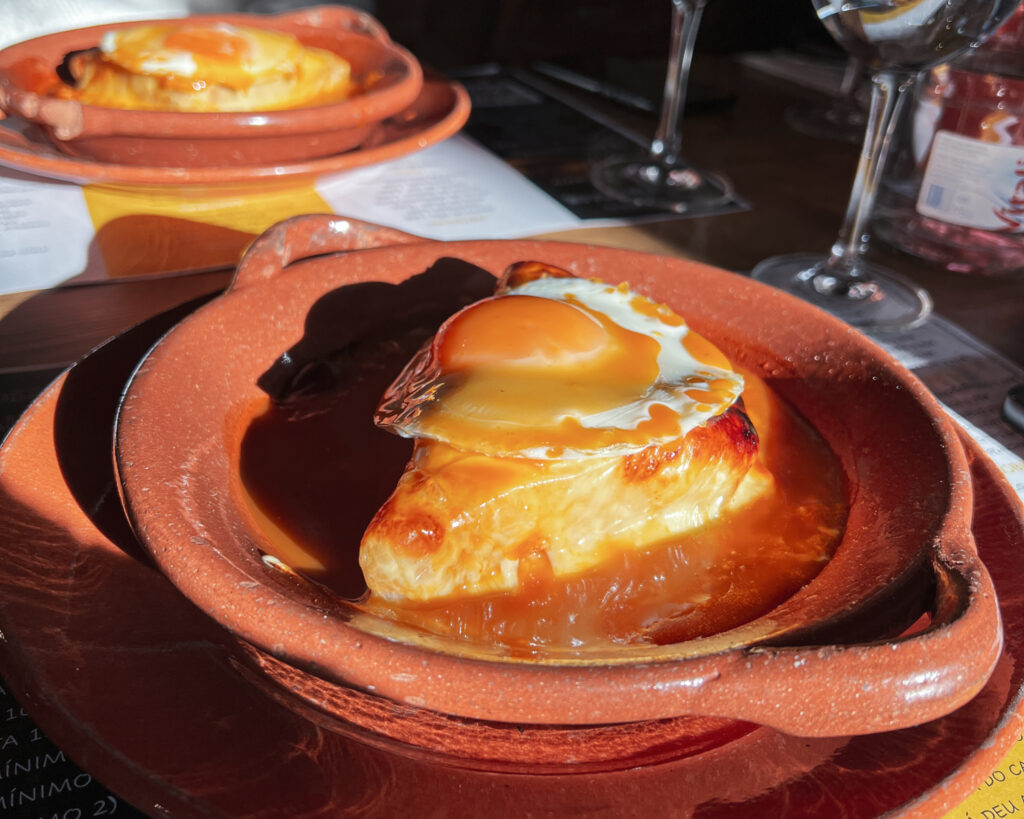 Photo of two Francesinha dishes at a restaurant. This is a traditional dish from Porto.