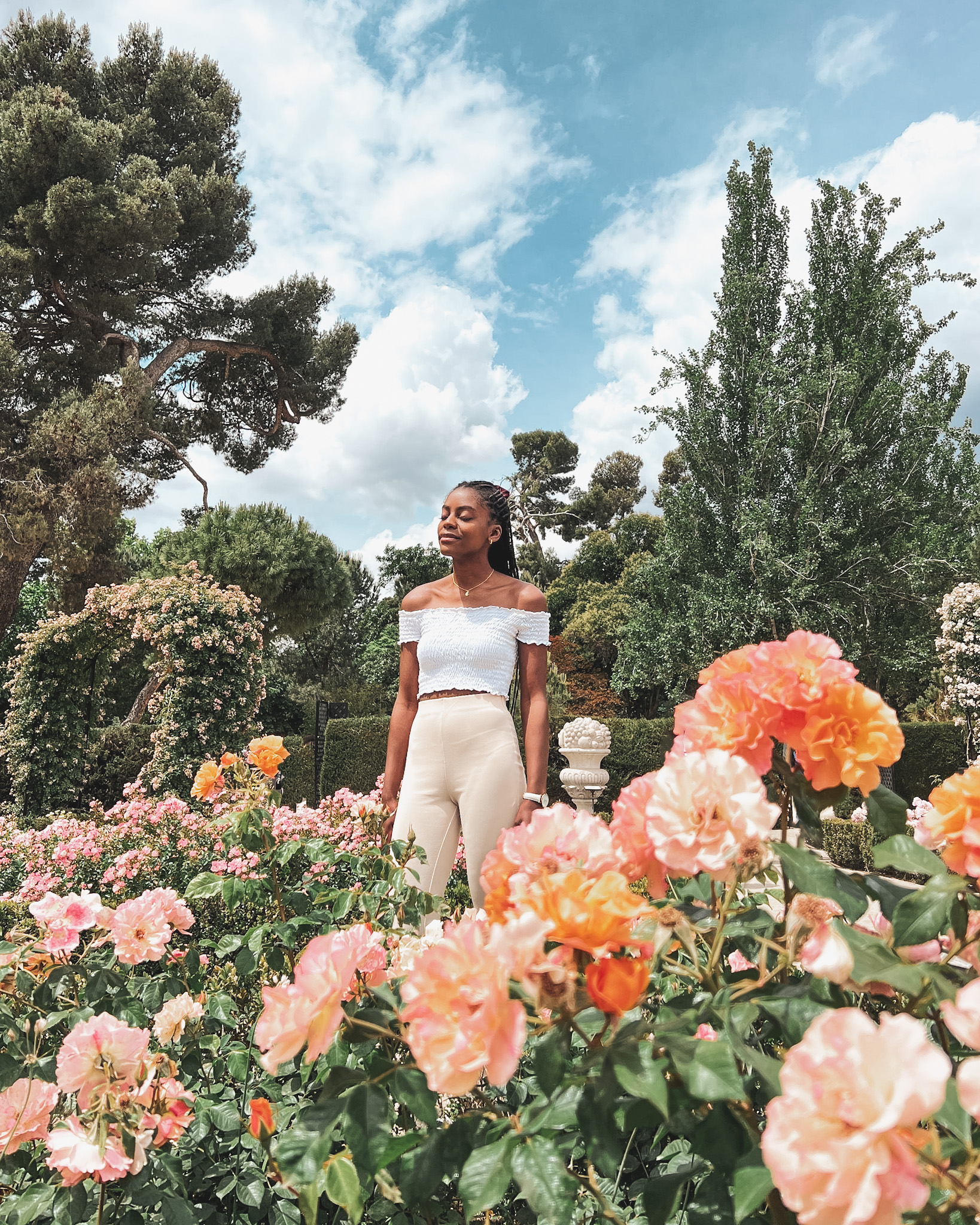 Woman in a botanical garden surrounded by flowers