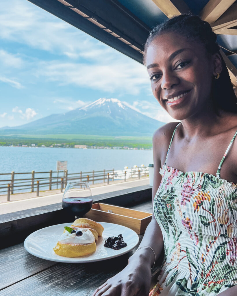 Woman at The Park Café eating pancakes in a porch terrace