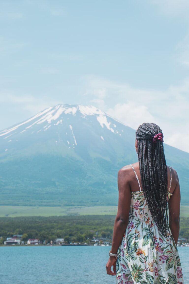 Woman with floral dress looking at Mount Fuji in the distance